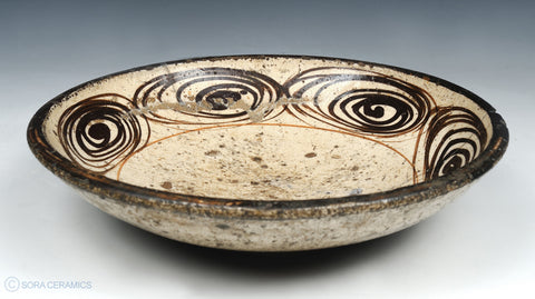 pottery bowl with brown swirl design
