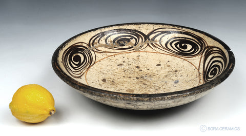pottery bowl with brown swirl design