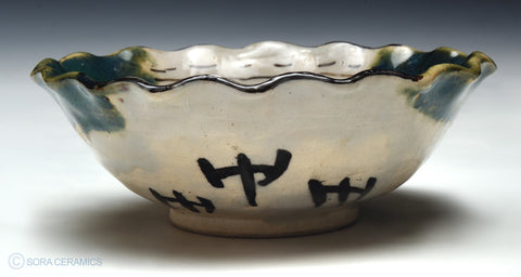 small bowl. fluted edge, green and yellow glazes,  painted interior