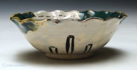 small bowl. fluted edge, green and yellow glazes,  painted interior