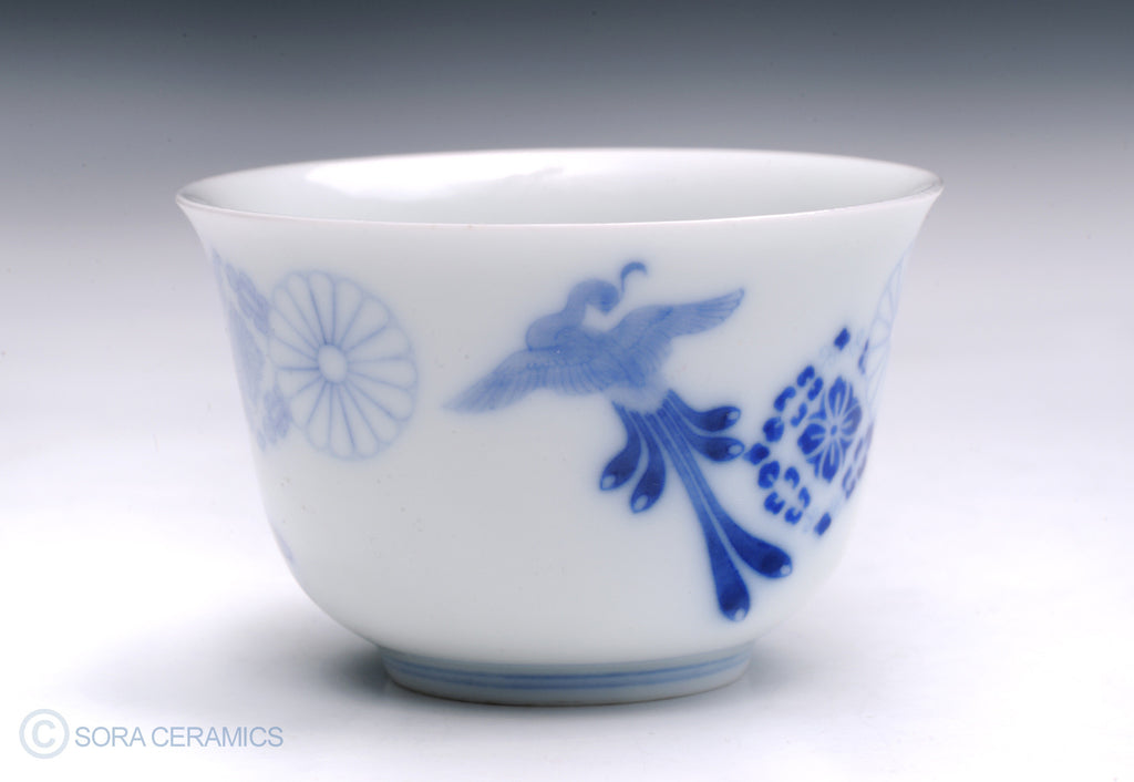 white cup with blue floral designs