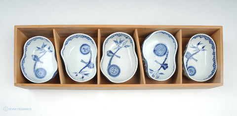 asymmetrically shaped blue and white small deep bowls